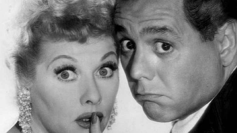 Lucille Ball and Desi Arnaz staring