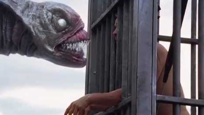 A Sea Beast stares down a man in a shark cage