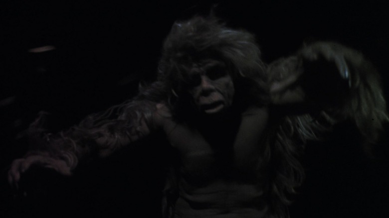 A humanoid Bigfoot raises its arms 