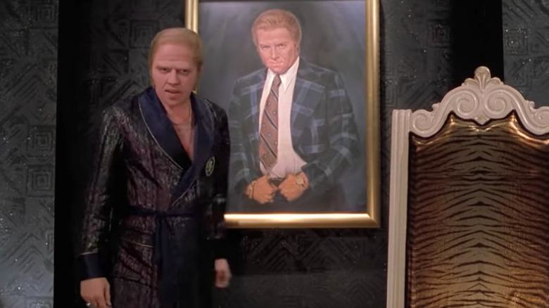 Rich Biff standing by his portrait