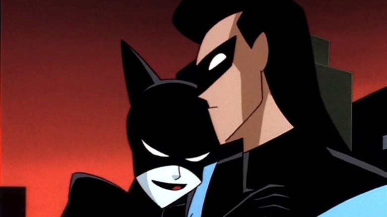 Catwoman puts her head on Nightwing's shoulder