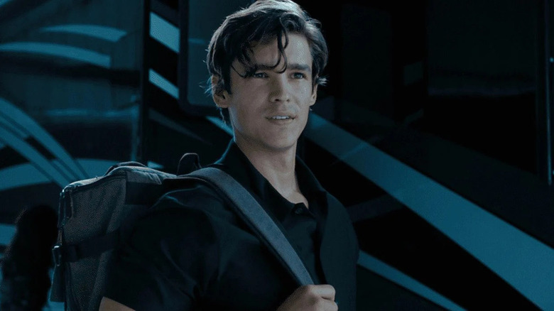 Brenton Thwaites holding backpack strap