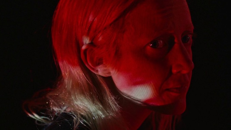 Andrea riseborough in red lighting