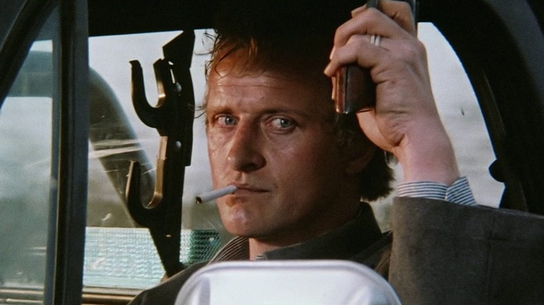 The hitcher smokes in car