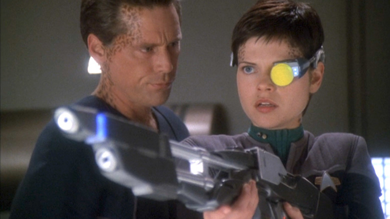 Ezri holds a rifle