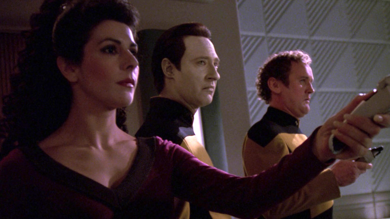 Troi, Data, and O'Brien point phasers