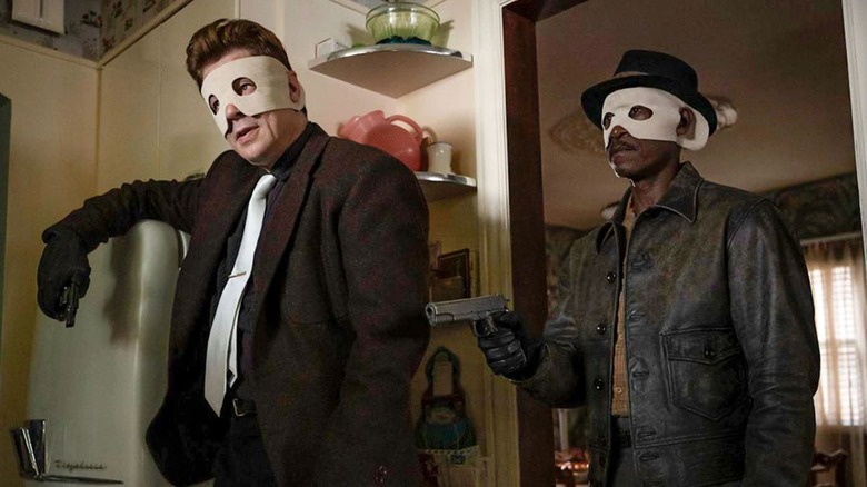 Don Cheadle and Benicio del Toro wearing masks