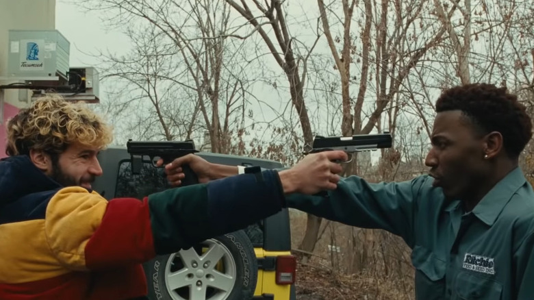 Jerod Carmichael and Christopher Abbott pointing guns