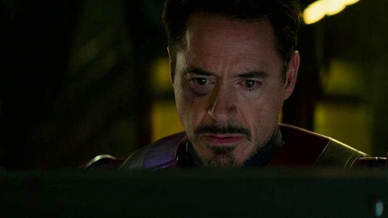 Tony Stark looks stunned and sad watching a monitor in Civil War