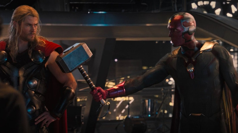 Vision hands a surprised Thor his hammer in Age of Ultron