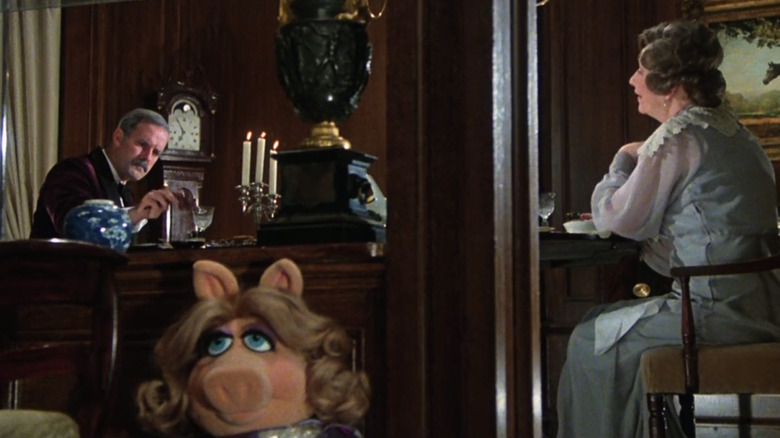 Miss Piggy sneaking past John Cleese and Joan Sanderson