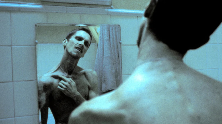 Christian Bale looking in mirror in The Machinist