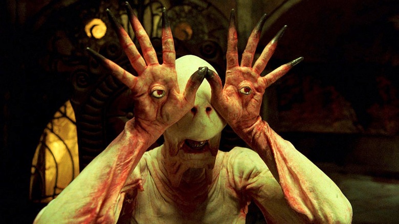 Pale Man hands in eyes