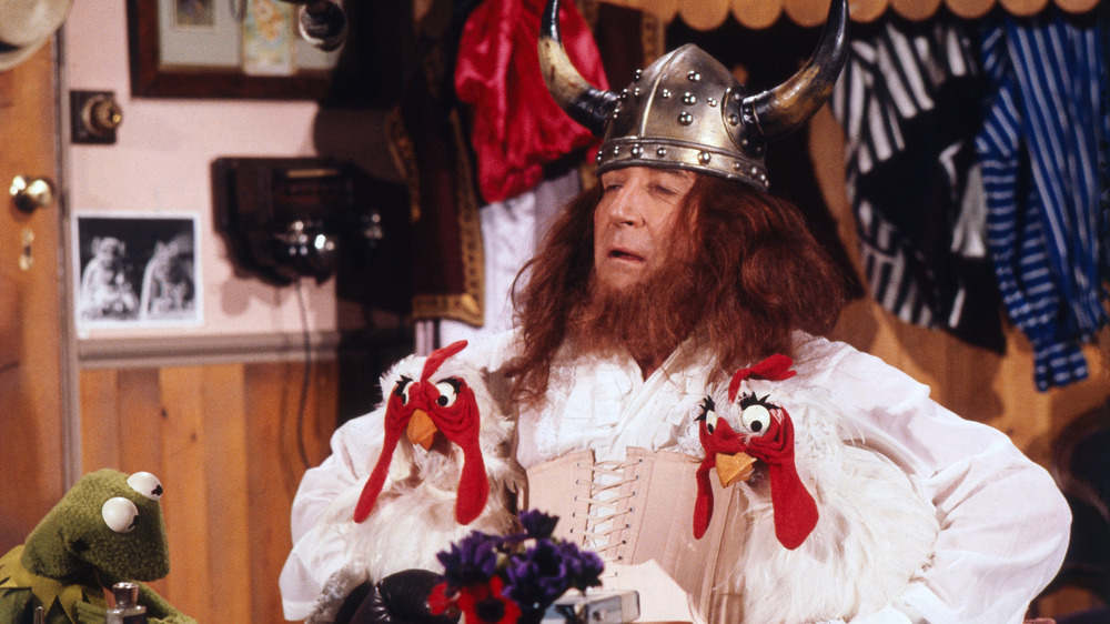 Peter Sellers dressed as a viking holding chickens