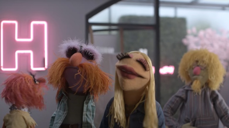 The Muppets standing in the office