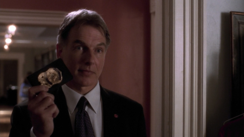 Mark Harmon holding up badge