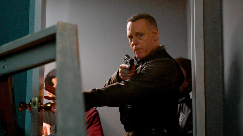 Chicago P.D.'s Voight opening door with gun in hand