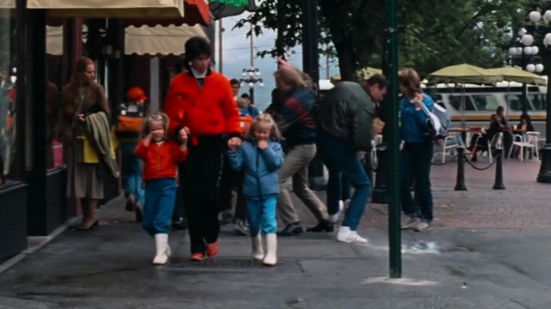 Man drops milk on crowded street