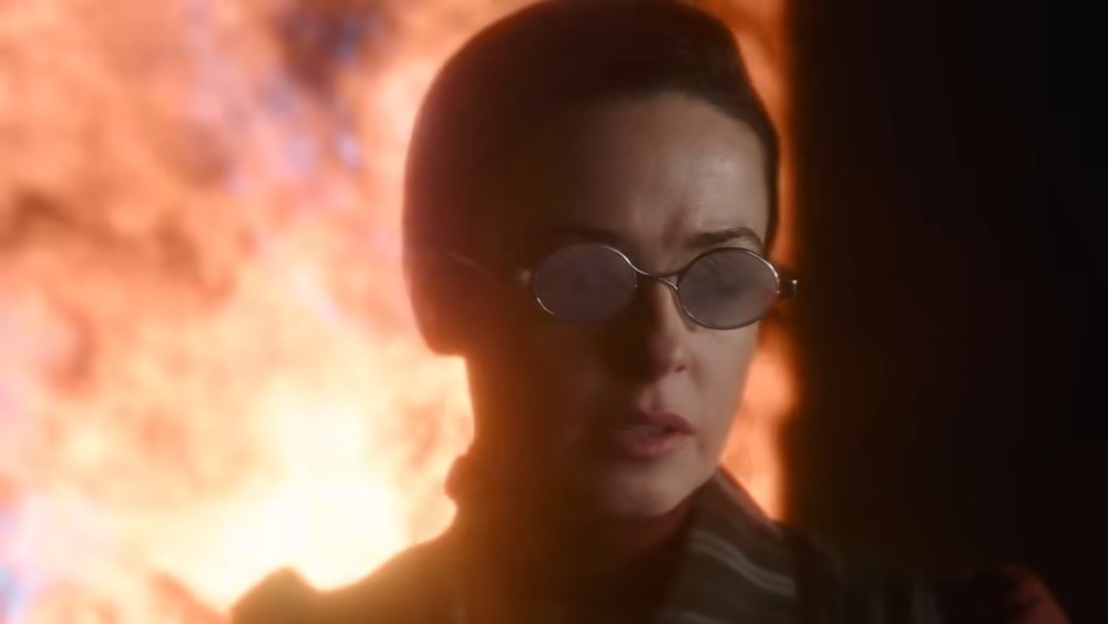 The Nevers character wearing glasses