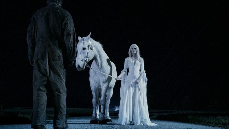 Michael Myers walking up to his mother and a white horse