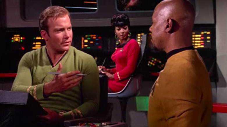 Kirk, Uhura, and Sisko on the bridge of the Enterprise