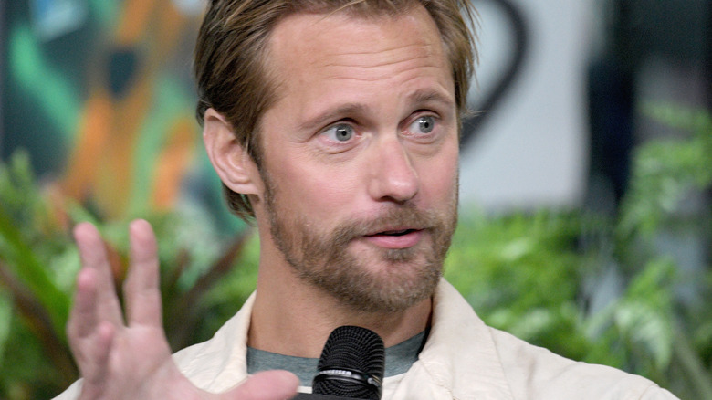 Alexander Skarsgård speaking into microphone