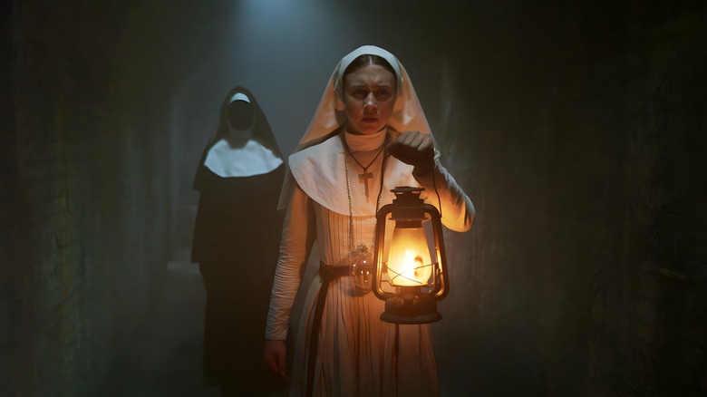 The Nun 2 snarling behind nun with lamp