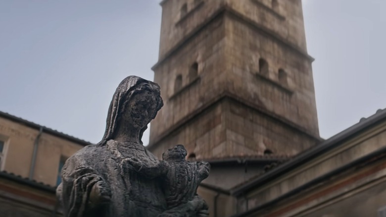 Worn statue of a nun holding baby