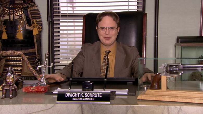 Dwight sitting at the boss's desk