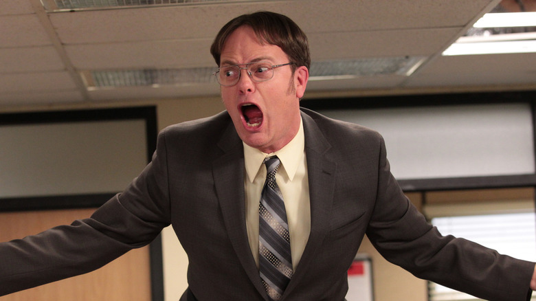 Dwight Schrute yelling on table in The Office