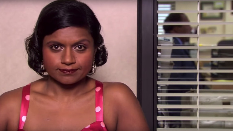 Kelly Kapoor smiles for camera crew