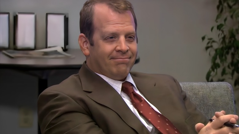 Toby Flenderson seated looking smug