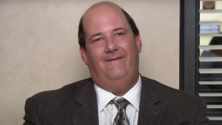 Kevin Malone sitting at desk