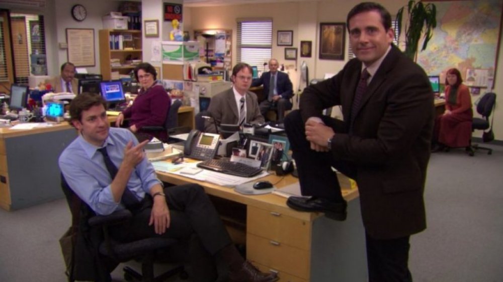 The Office cast, Steve Carell standing with his foot on Jim's desk