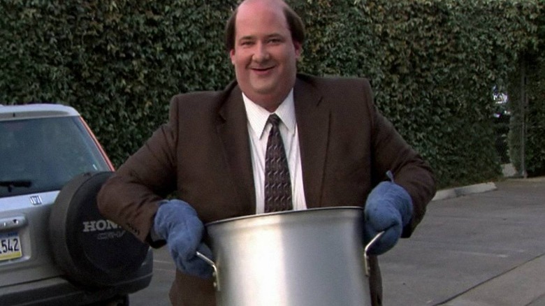 Kevin Malone carrying his pot of chili