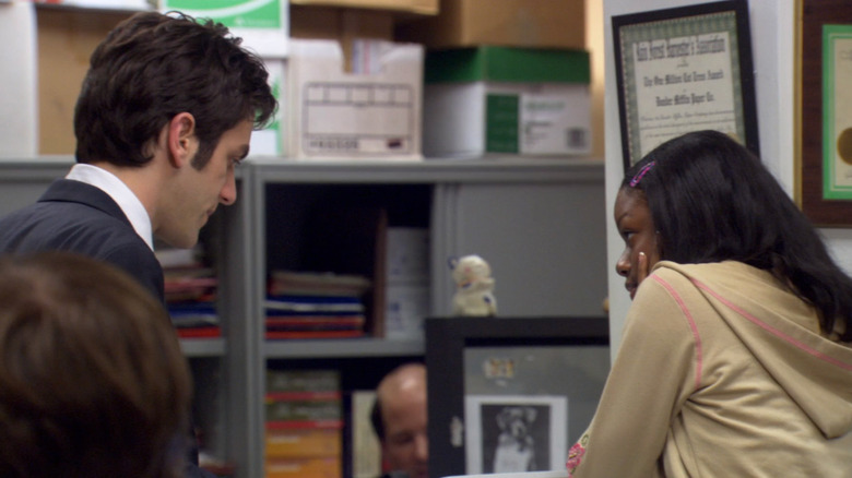 Ryan and Melissa talking near supply shelves