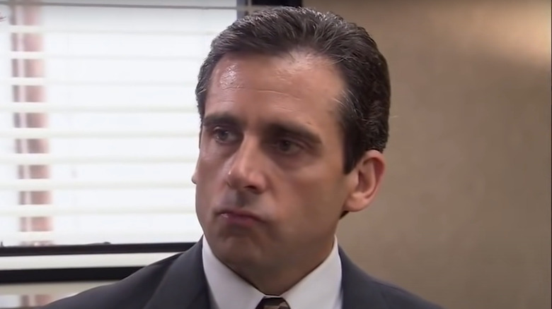 Michael Scott looking at the pyramid scheme drawing