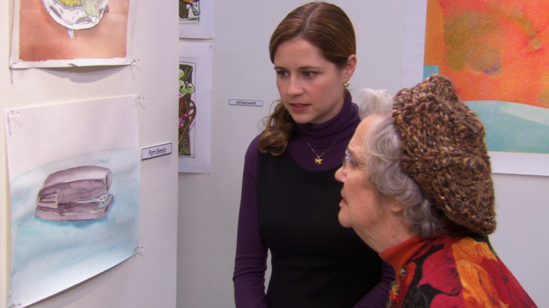 Pam in front of her artwork