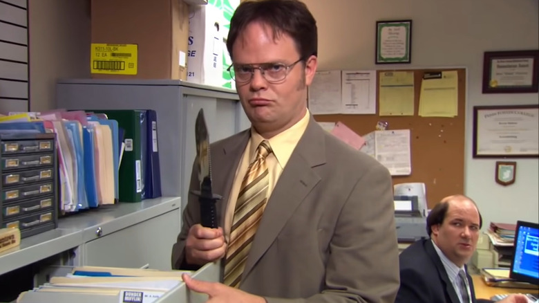 Dwight holds a knife