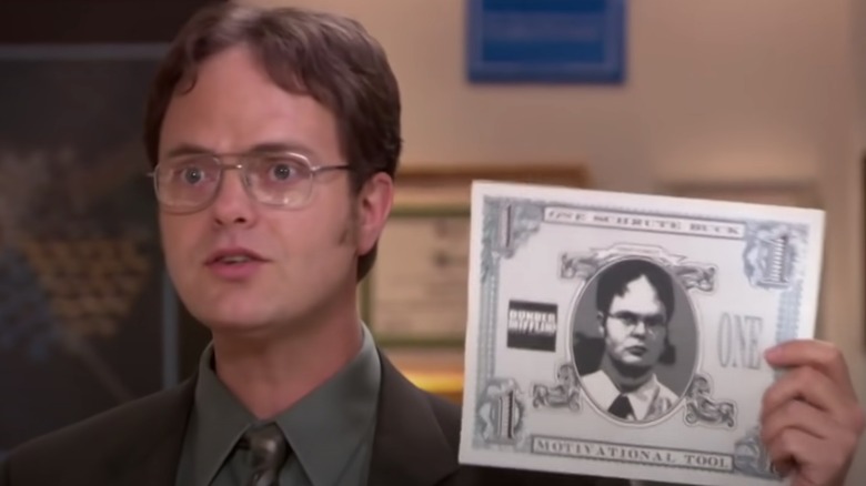 Dwight holding Schrute Bucks