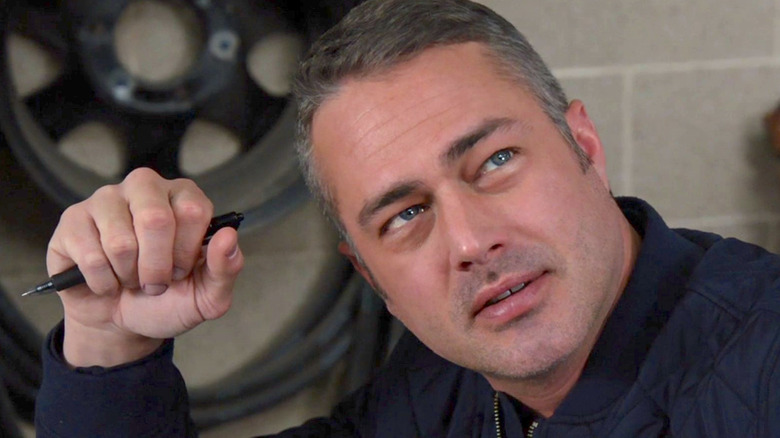 Kelly Severide gripping a pen