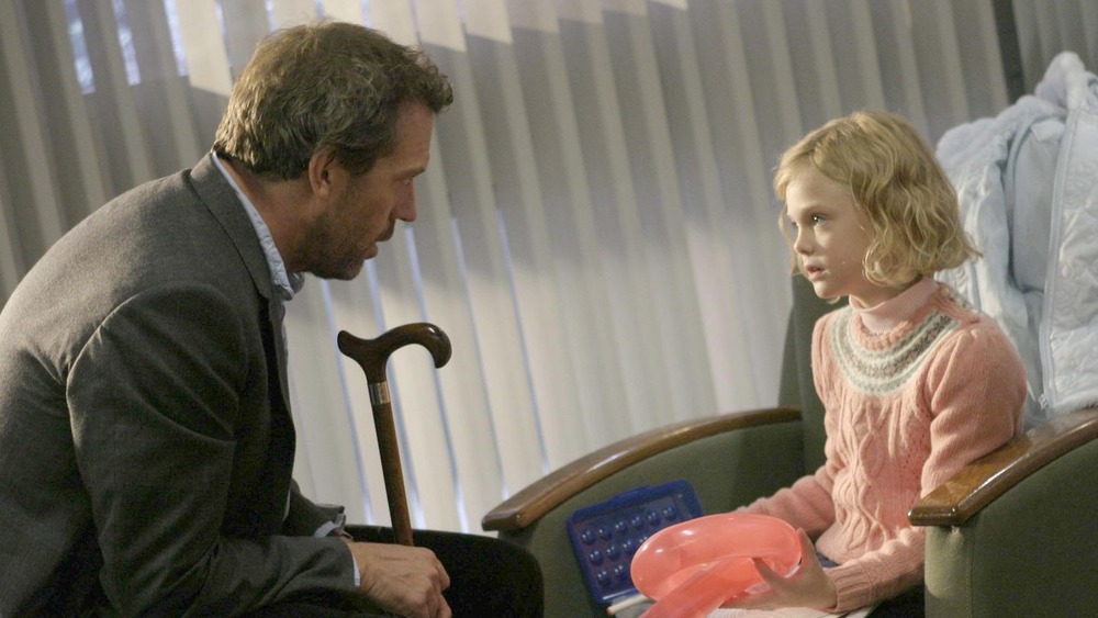 House talking to little girl