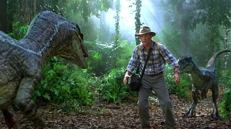 Alan Grant looking at a dinosaur