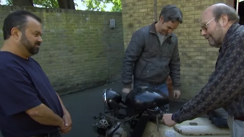 Mike Wolfe and Frank Fritz inspect a precious motorcycle