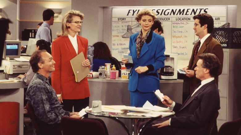 Murphy and cast around desk