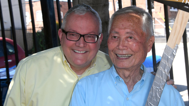 George Takei and husband smiling