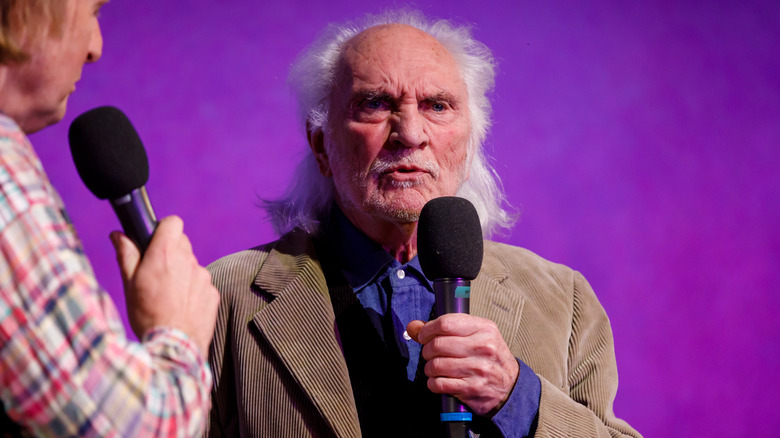 Terence Stamp talking in microphone