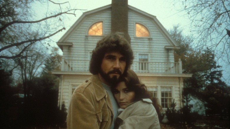 George and Kathy in front of house