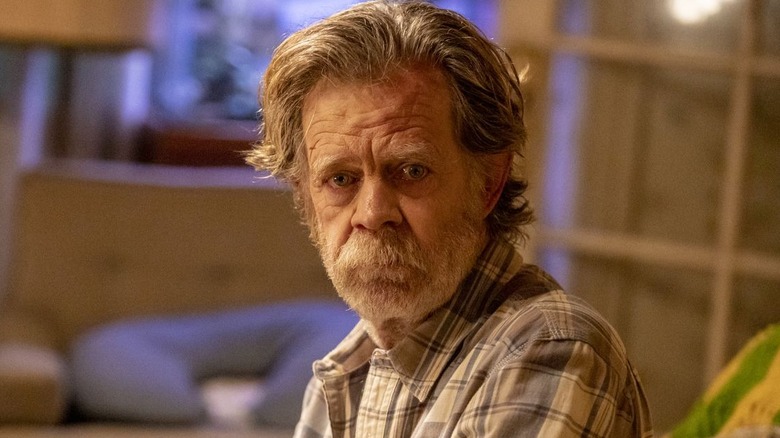 William H. Macy as Frank Gallagher sits on a couch