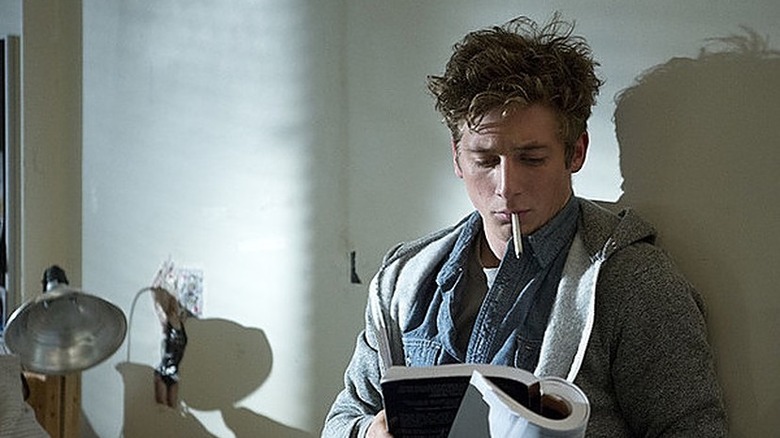 Jeremy Allen White as Lip Gallagher reads a book while smoking a cigarette